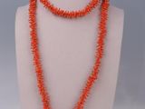 a necklace made of coral coral beads on a mannequin