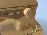 a gold sewing machine sitting on a white surface