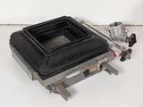 a black camera lens sitting on top of a metal stand