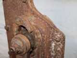 an old rusted metal door handle on a white wall
