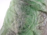 a close up of a piece of green marble with mold on it