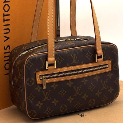 a brown and black bag sitting next to a brown box