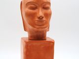 sculpture of a woman ' s head on a square base