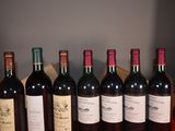 several bottles of wine are lined up on a table