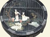 a black box with a painting of a woman and two dogs