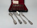 silverware in a red case on a white surface with a note in it