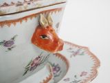 a bowl with a lid and a plate with a fish on it