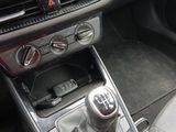 the interior of a car with a gear box and a shift button