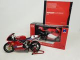 a toy motorcycle that is sitting next to a box