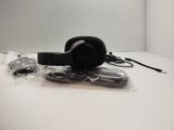 a black headphone sitting on top of a plastic bag