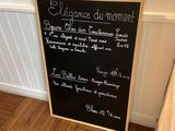 a chalk board with a menu on it in a room