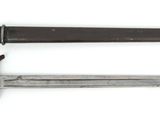 an old knife with a wooden handle sitting next to a smaller knife