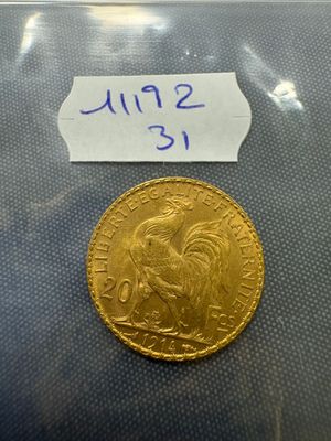 a close up of a gold coin with a label on it