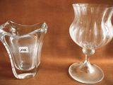 two glass vases sitting next to each other on a table