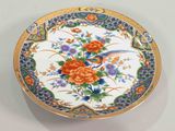 a decorative box with flowers on it on a white surface