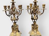 pair of antique brass candelabs with figurines on stands