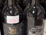 several bottles of wine are lined up on a shelf