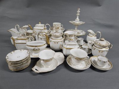 a lot of white and gold china on a table