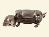 a silver pig and a piggy sitting on a table