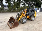 a small tractor that is parked in the dirt