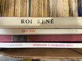 three books stacked on top of each other in a box