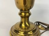 an image of a gold lamp on a white background with a cord