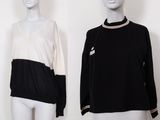 deux mannequins portant des chemises noires et blanches et un pull noir et blanc