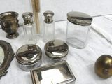 a table with a lot of silver objects on it
