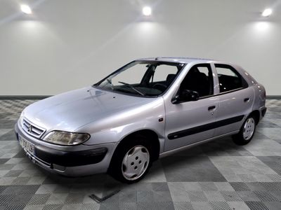 a silver car that is parked on a checkered floor