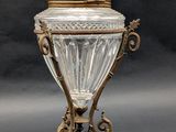 an antique silver plated glass covered jar with a bird on top