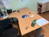a desk with a chair and a desk top with papers on it