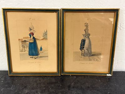 two framed prints of a woman in a blue dress and a man in a red hat