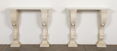two white marble tables sitting on top of a wooden floor