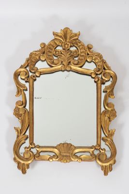 an image of a gold framed mirror on a white wall