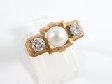 an image of a white pearl and diamond ring on a white surface