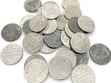 pile of silver coins on a white background