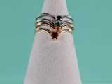 three different colored stones are set on top of a white cone