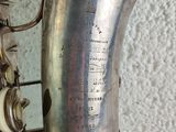 a silver saxophone that is sitting on a table