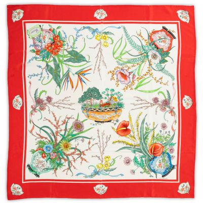 a close up of a red and white scarf with flowers and birds on it