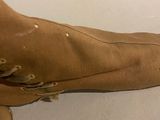 a close up of a person ' s foot wearing a pair of brown boots