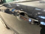 a close up of a car door handle with a sticker on it