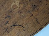 a close up of a wooden table with writing on it