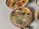 a close up of a gold pocket watch with a key