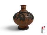 a brown vase with a design on it on a white background