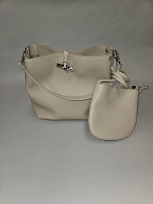 beige leather handbag and purse set on a white background