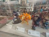 many different types of action figures on display in a glass case