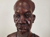 statue of a man with a beard and a necklace on his neck
