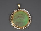 a green jade and diamond pendant