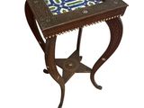 a small table with a blue and green tile top