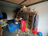 an image of a garage with a lot of clutter on the floor